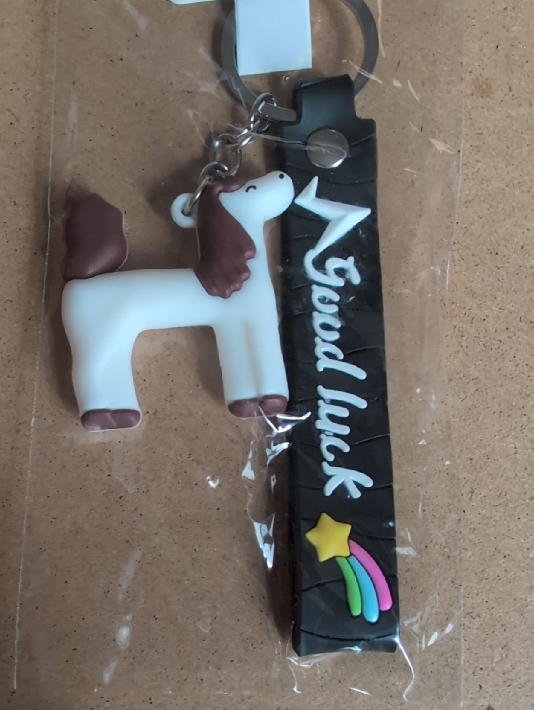 White Pony Keychain With Brown Mane And Black 'Good Luck' Strap